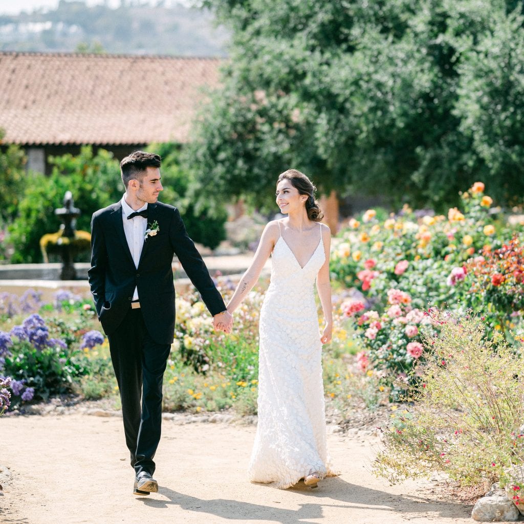 Bride and groom walking in a beautiful garden by Amy Huang Photography a Wedding Photographer in San Diego