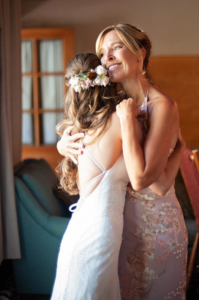 A sweet mommy and daughter hug during Kayla and Jackson's Rustic Mammoth Lake Wedding, Photo taken by Amy Huang Photography