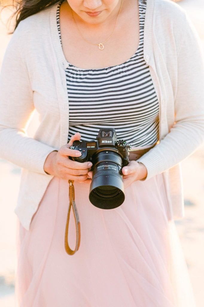Amy Huang Photography holding a Nikon Z6 camera photos by The Fourniers of a wedding phtoographer in San Diego