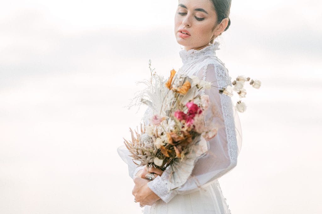 beautiful bride in a antique dress and a dry bouquet by Amy Huang Photography, a San Diego Photographer styled by wedding stylist Angel Tan