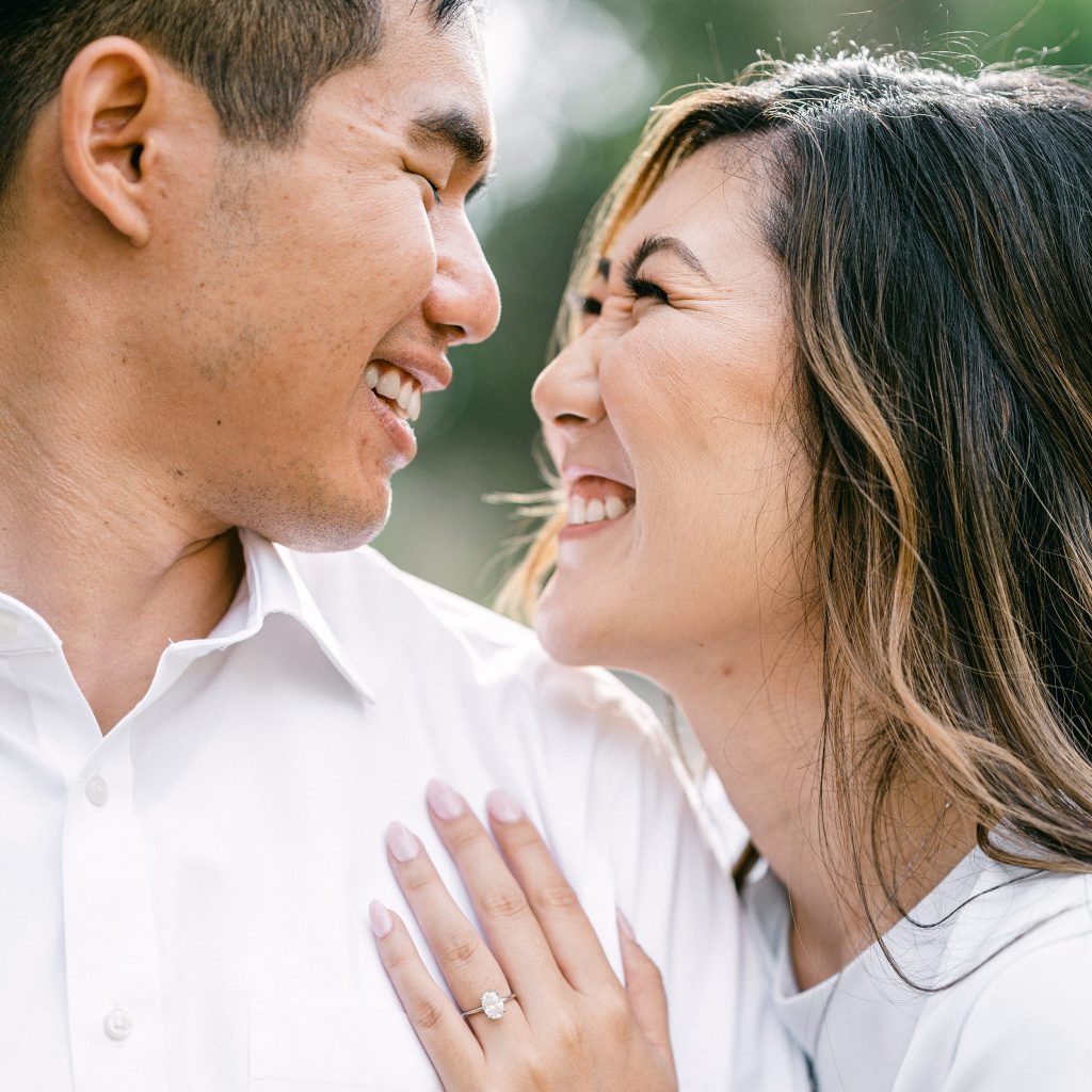 Bride smiling happily with her groom to be by Amy Huang Photography, a San Diego Photographer